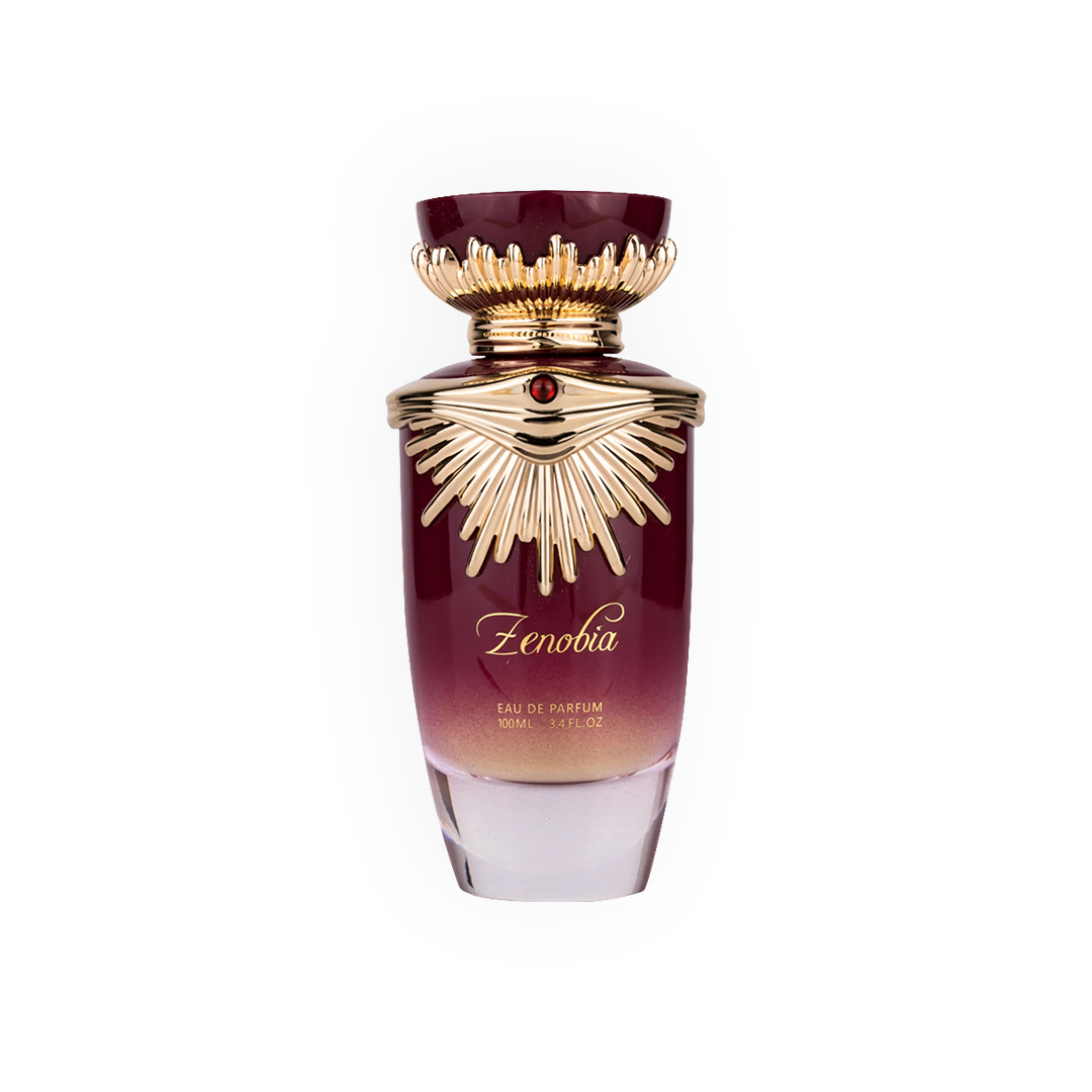 Parfum Zenobia 100ml - Gulf Orchid. Flacon luxueux dégradé bordeaux et doré avec un bouchon orné d’un design rayonnant, sublimé par une pierre rouge centrale. Eau de parfum pour femme aux notes riches, orientales et sophistiquées. Idéal pour une allure élégante et majestueuse.